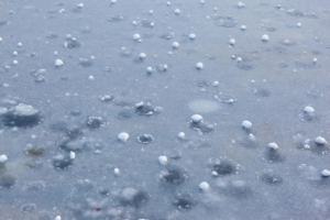 hail hitting the street in rain storm